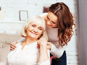 caregiver and senior woman are smiling